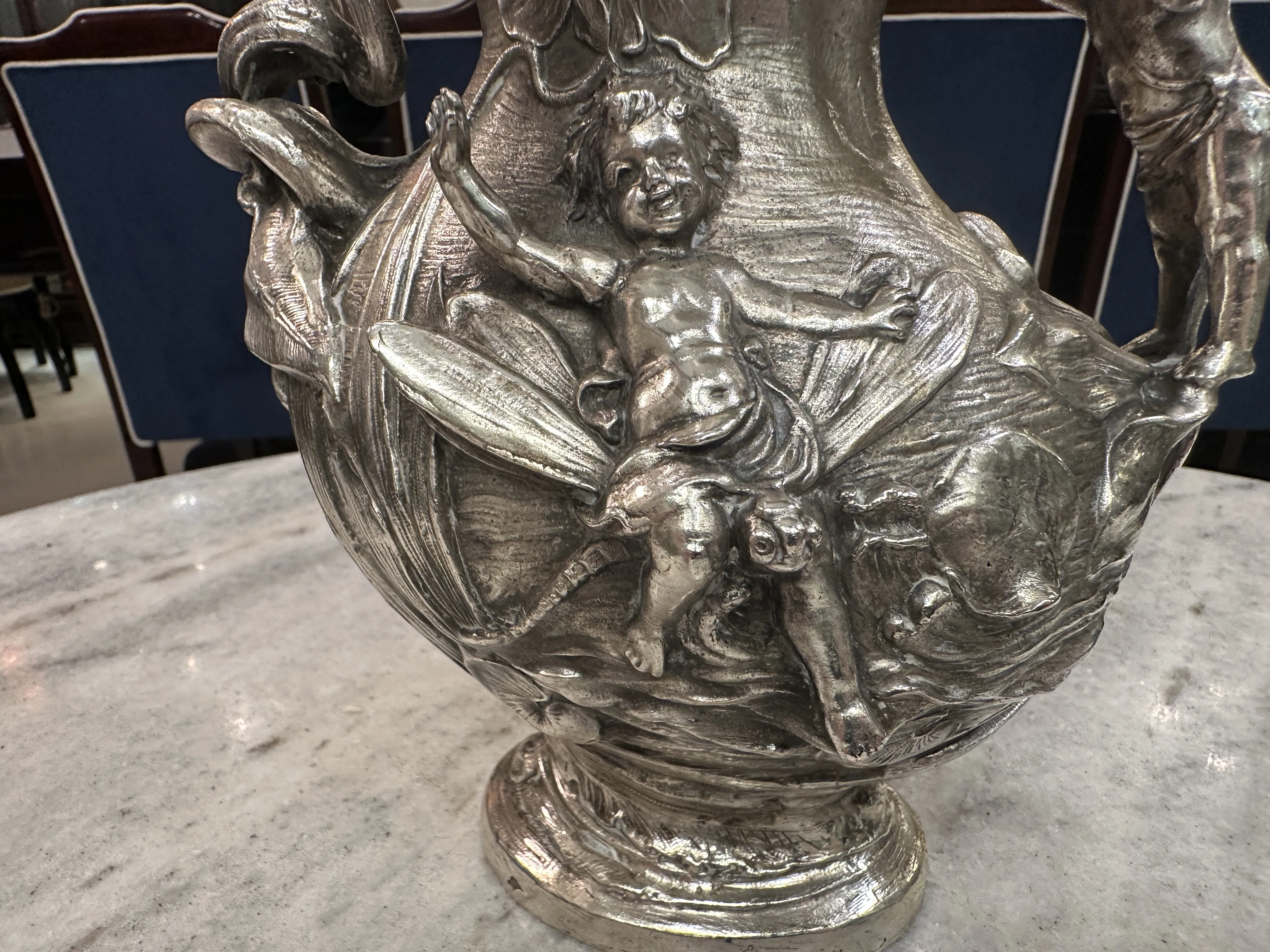 antique jar featuring intricate design and decorative figures