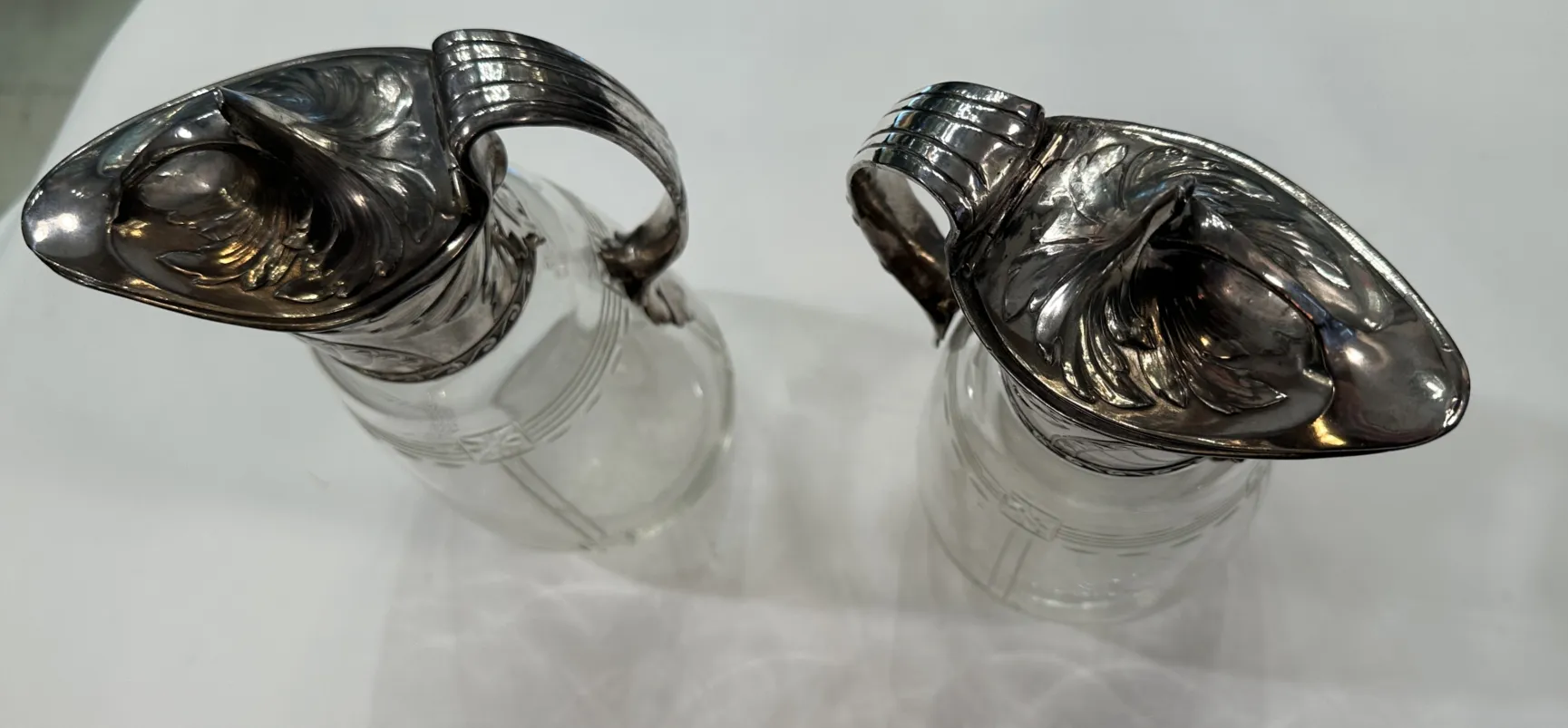 Two antique WMF jars featuring decorative details and an elegant design in a classic setting.