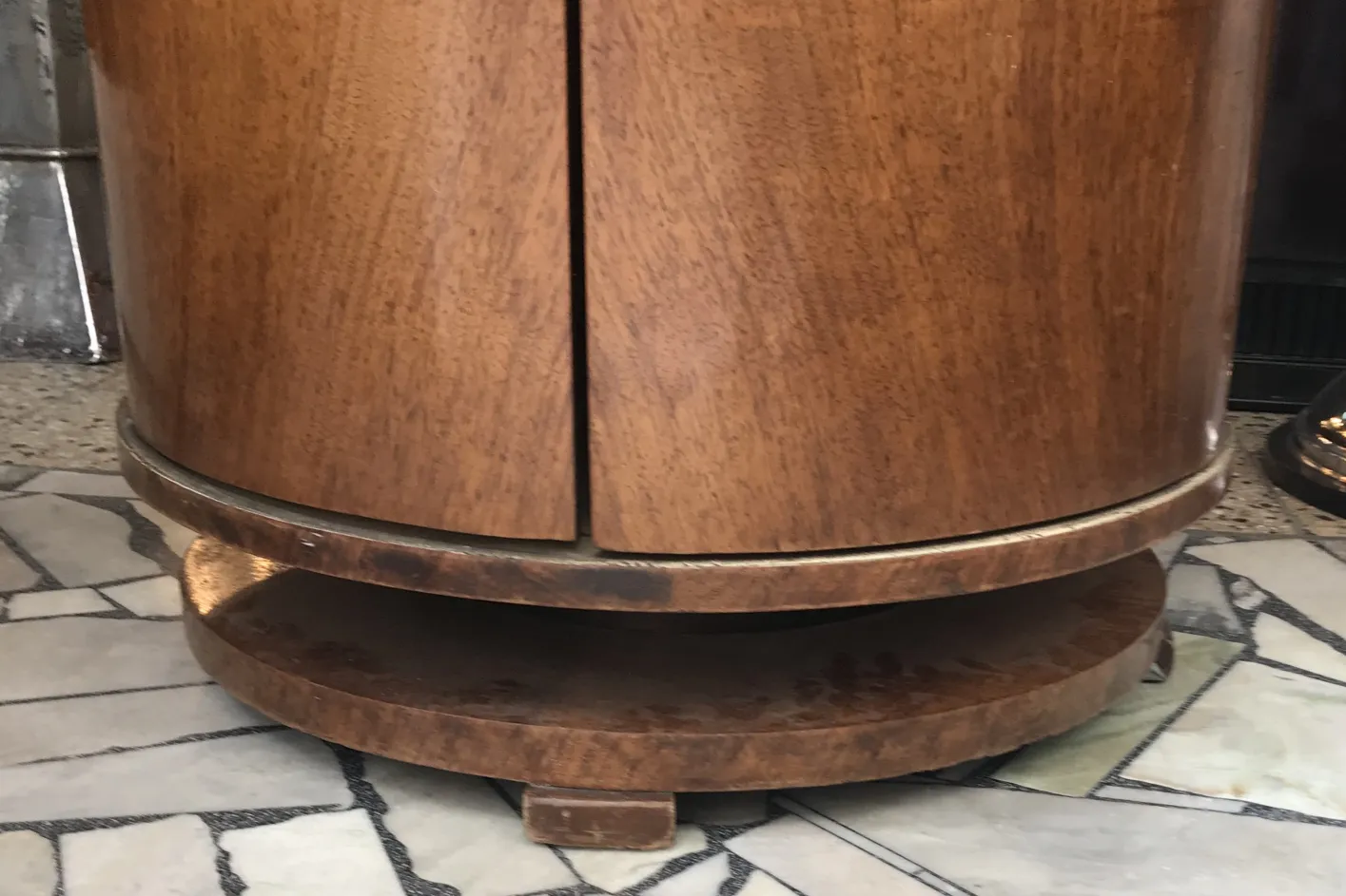 Vintage round bar cabinet made of wood in elegant setting.