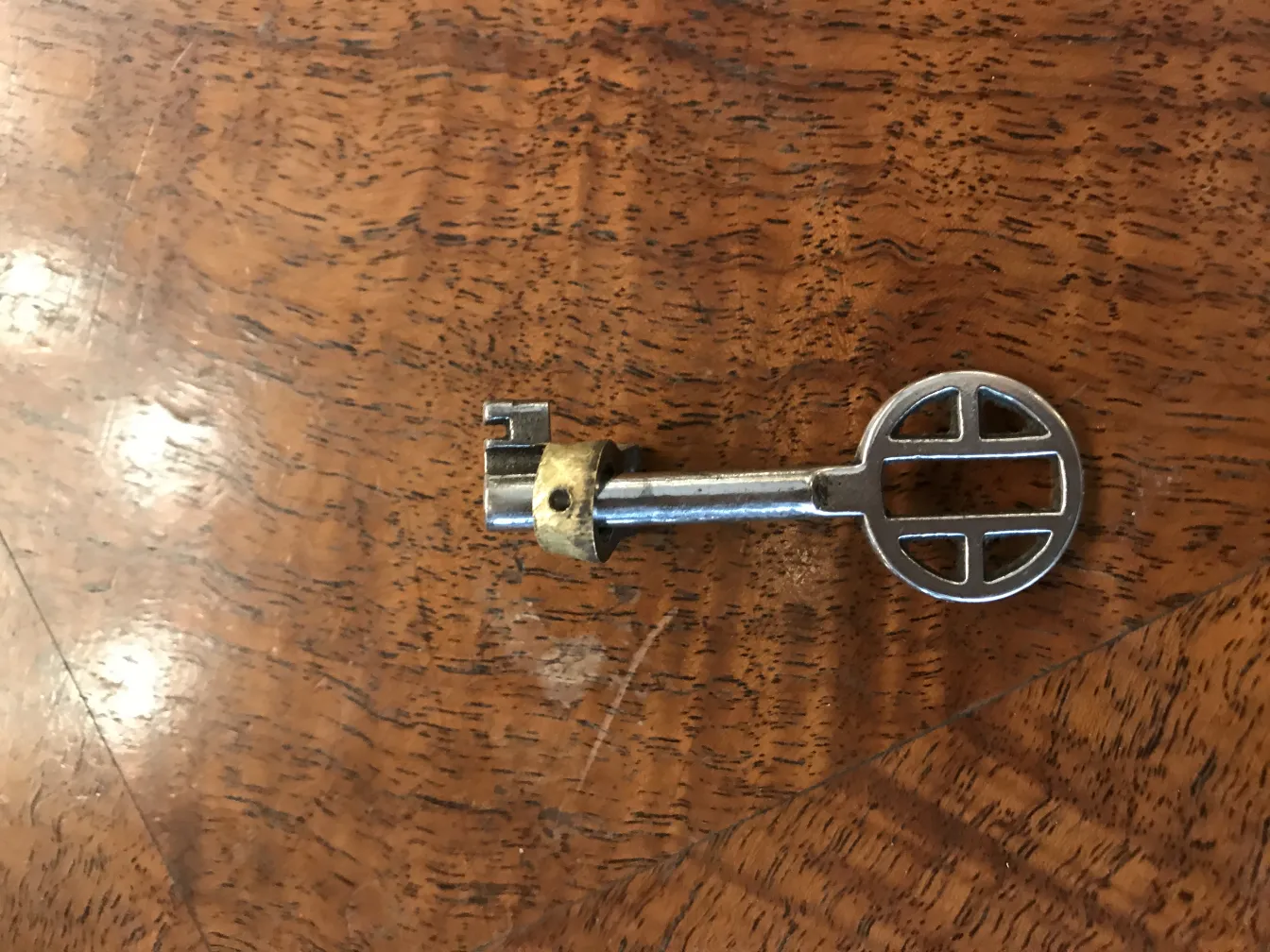 Antique bar with a decorative key on wooden surface.