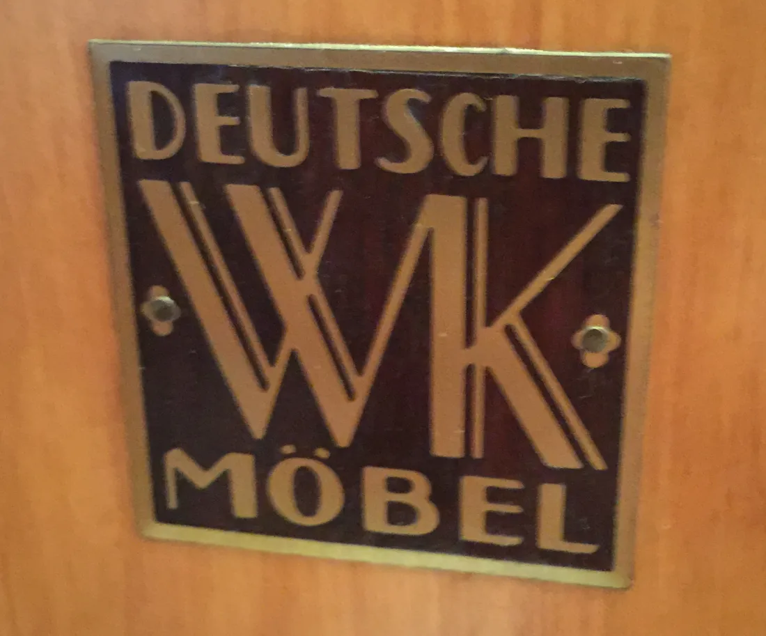 Antique bar with Deutsche brand plate on wooden background.