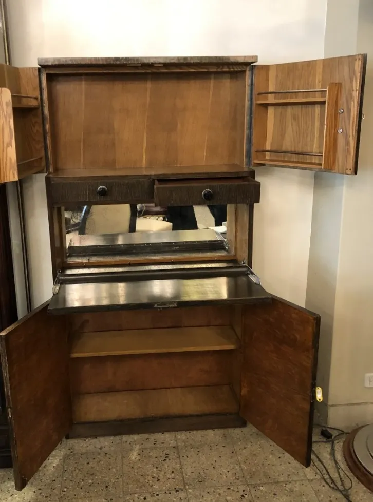 Antique bar with a mirror, shelves and elegant design.