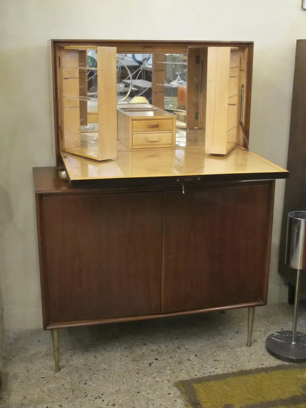 고전적인칵테일캐비닛에거울과내부선반이있습니다.