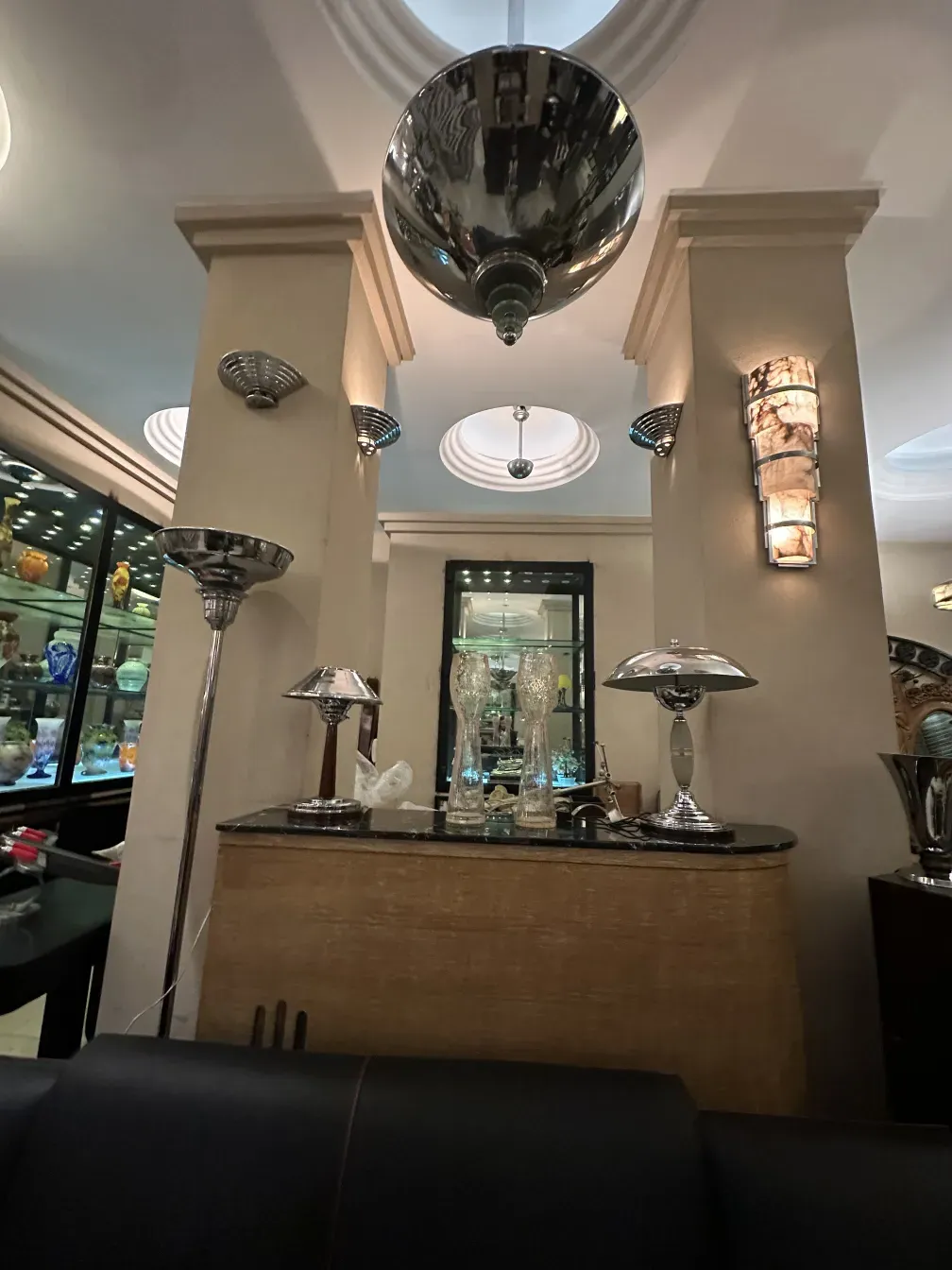 Antique bar with mirror and lights, elegantly decorated.