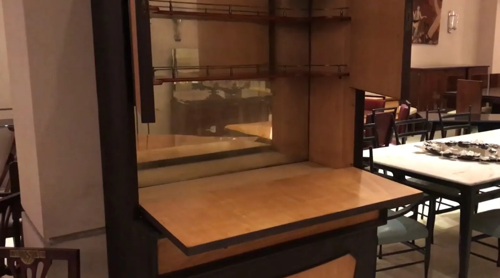 Antique wooden bar cabinet with shelves and wide surface