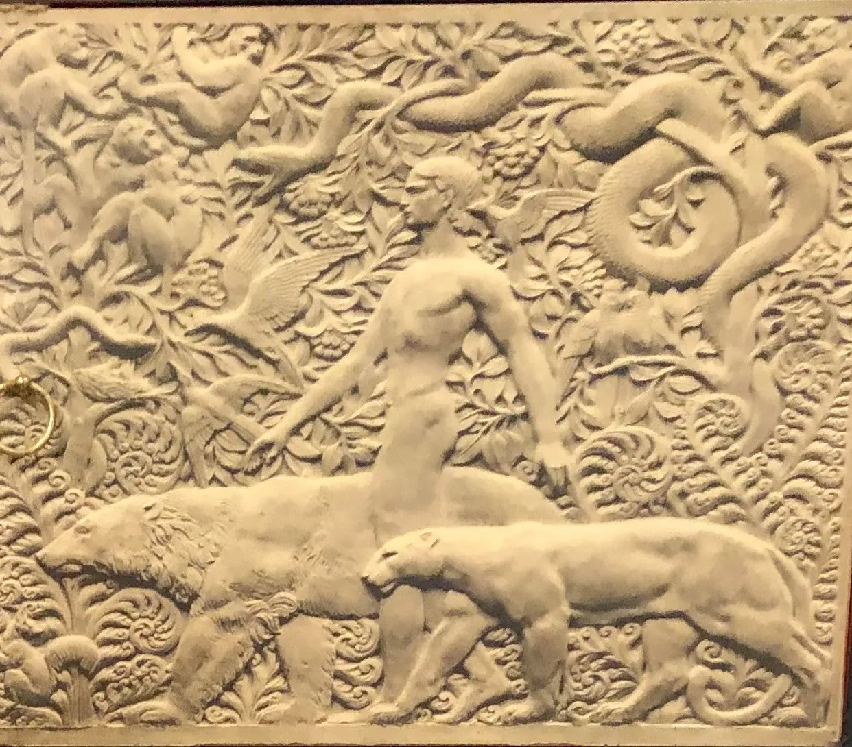 artistic relief of an old library with animals and vegetation