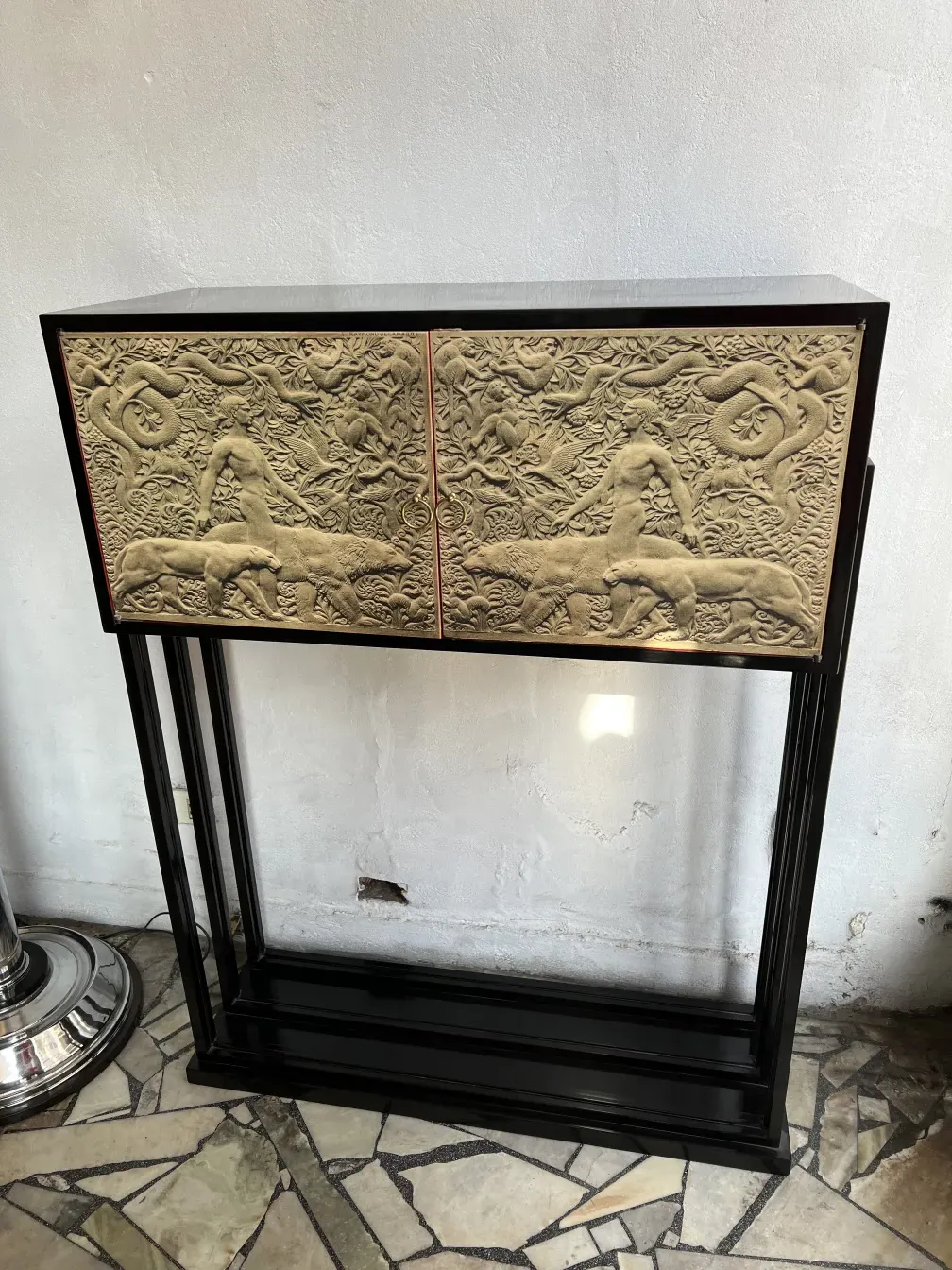 Mueble bar antiguo con diseño en relieve, en ambiente elegante