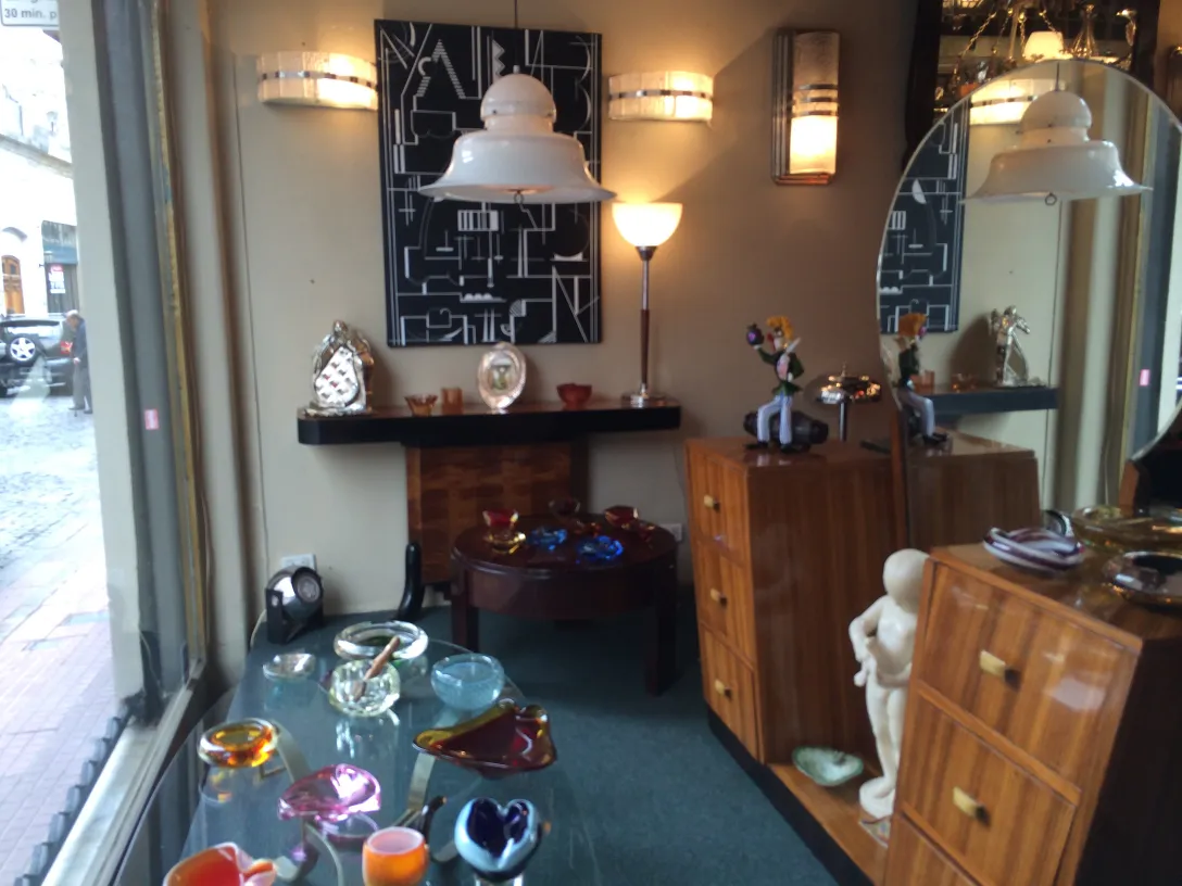 Pair of antique sconces in a vintage store decor with various items.