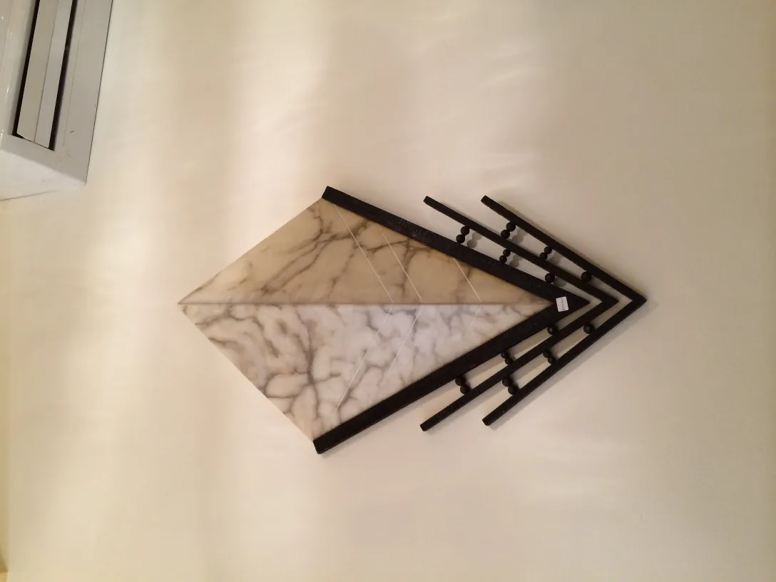 Pair of antique sconces elegantly mounted on a light wall, featuring decorative details.