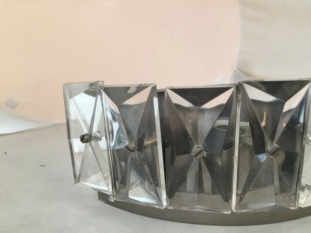 Pair of antique wall sconces with elegant base and crystal