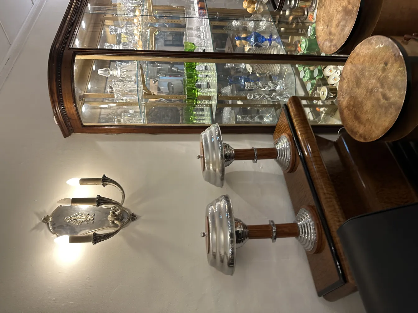 Antique pair of sconces featuring elegant design and warm light, suitable for classic decor.