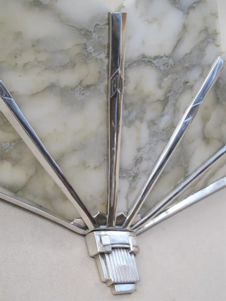 Pair of antique sconces with artistic design, providing soft lighting in an elegant setting.