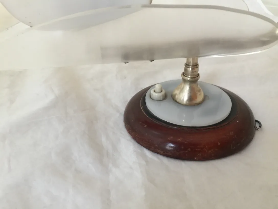 나무와 광택 있는 금속 베이스의 고풍스러운 벽등 한 쌍, 아늑한 환경에서.