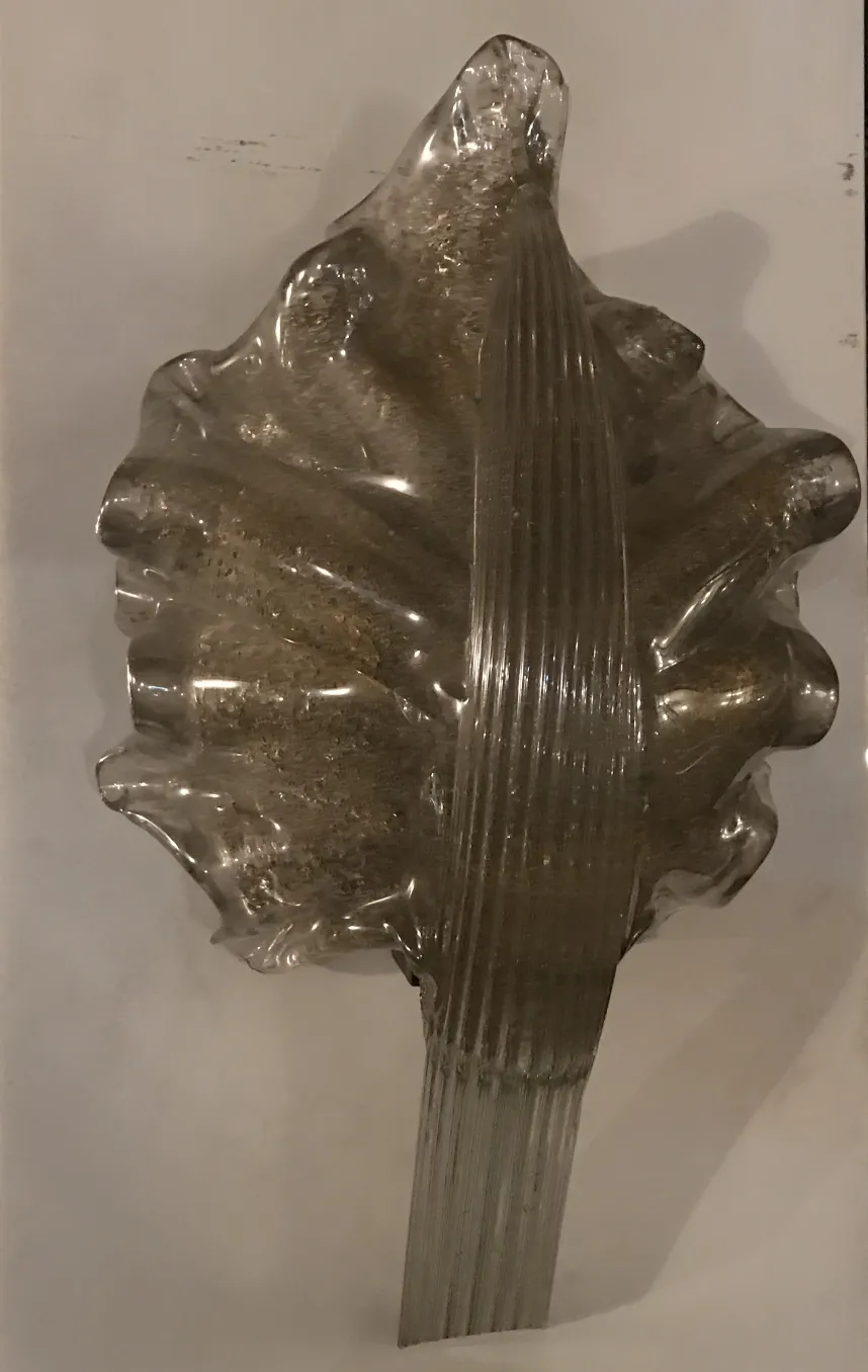 Pair of antique sconces with translucent design, brightening a cozy setting.