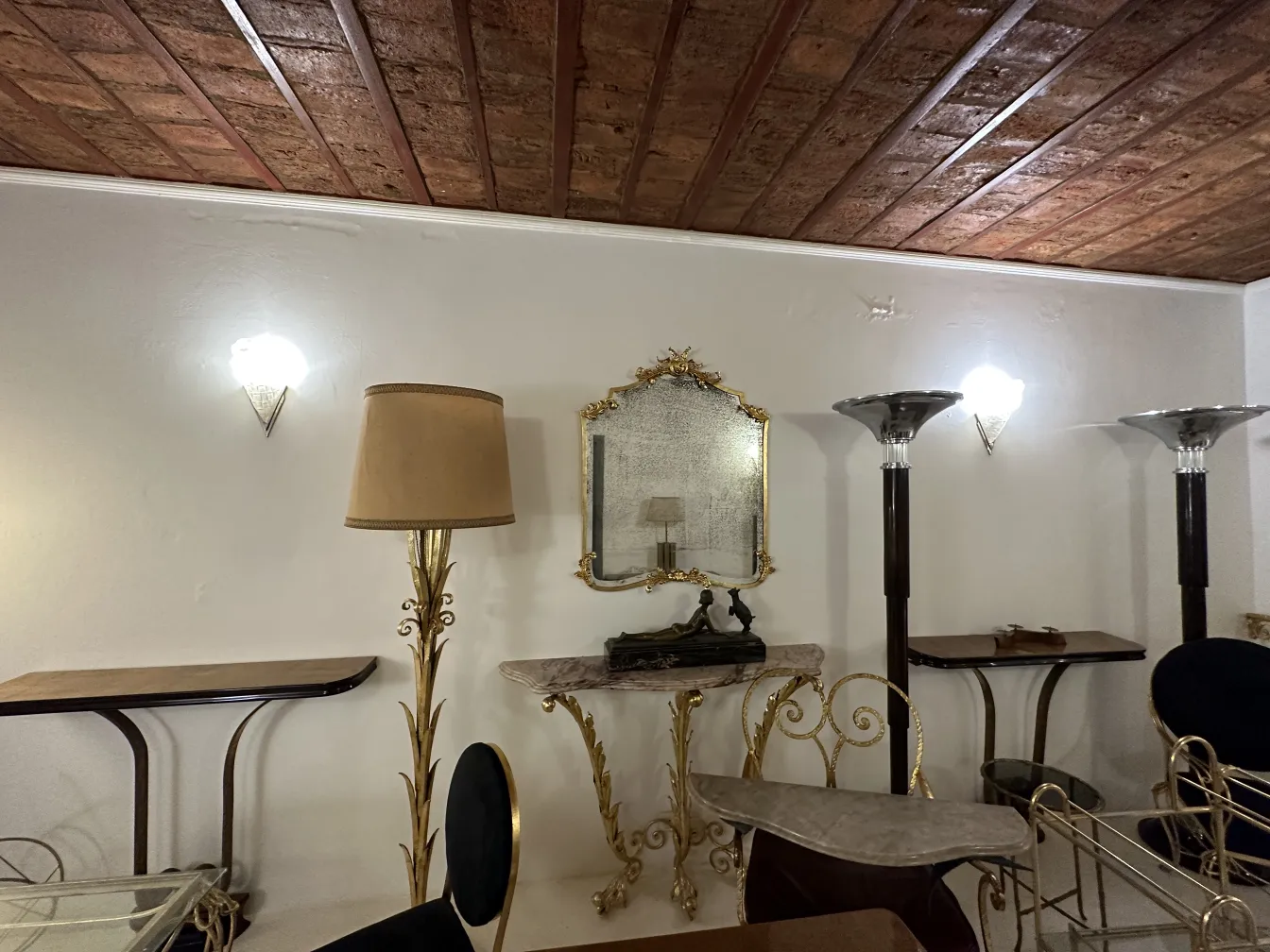 pair of antique sconces in a vintage room with golden decor