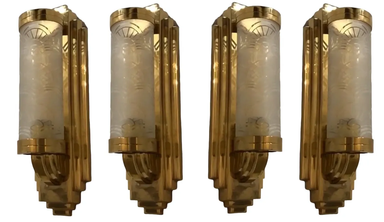 Elegant pair of antique sconces in gold finish with white shades.