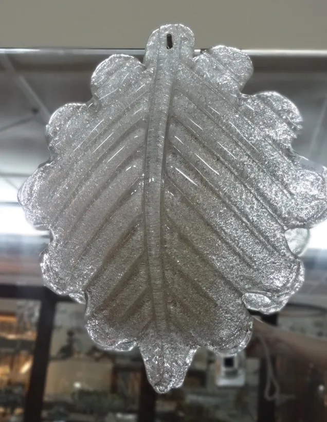 Paire d'appliques anciennes en forme de feuilles, avec des paillettes délicates dans un cadre vintage.