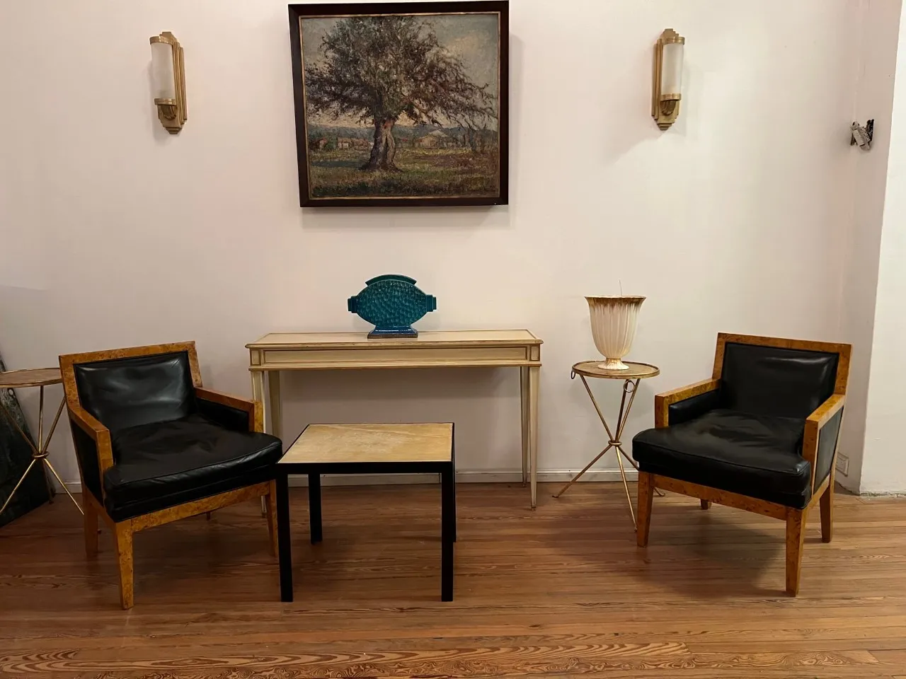 Paar antiker Wandleuchter mit sanftem Licht und klassischem Design, die eine gemütliche Umgebung mit Stühlen und Tisch verschönern.