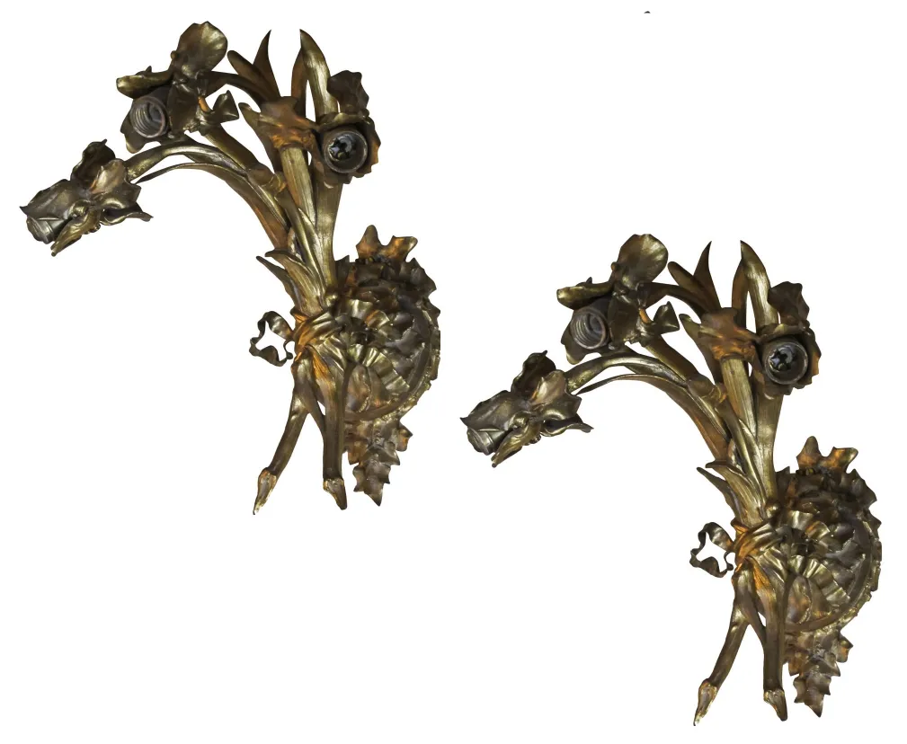 Pair of antique sconces featuring floral shapes, perfect for decor.