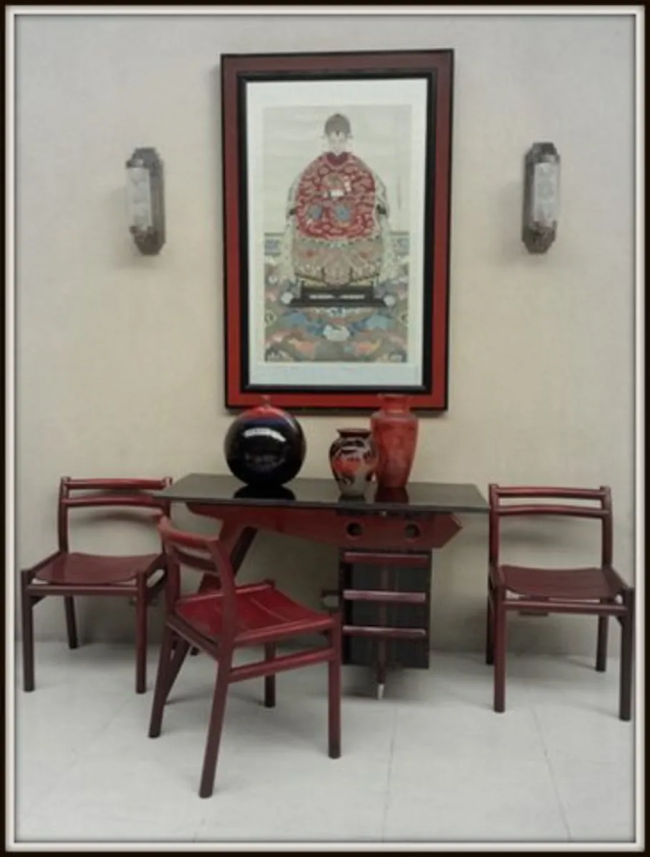 Antique wall sconces beside decorative art frame.