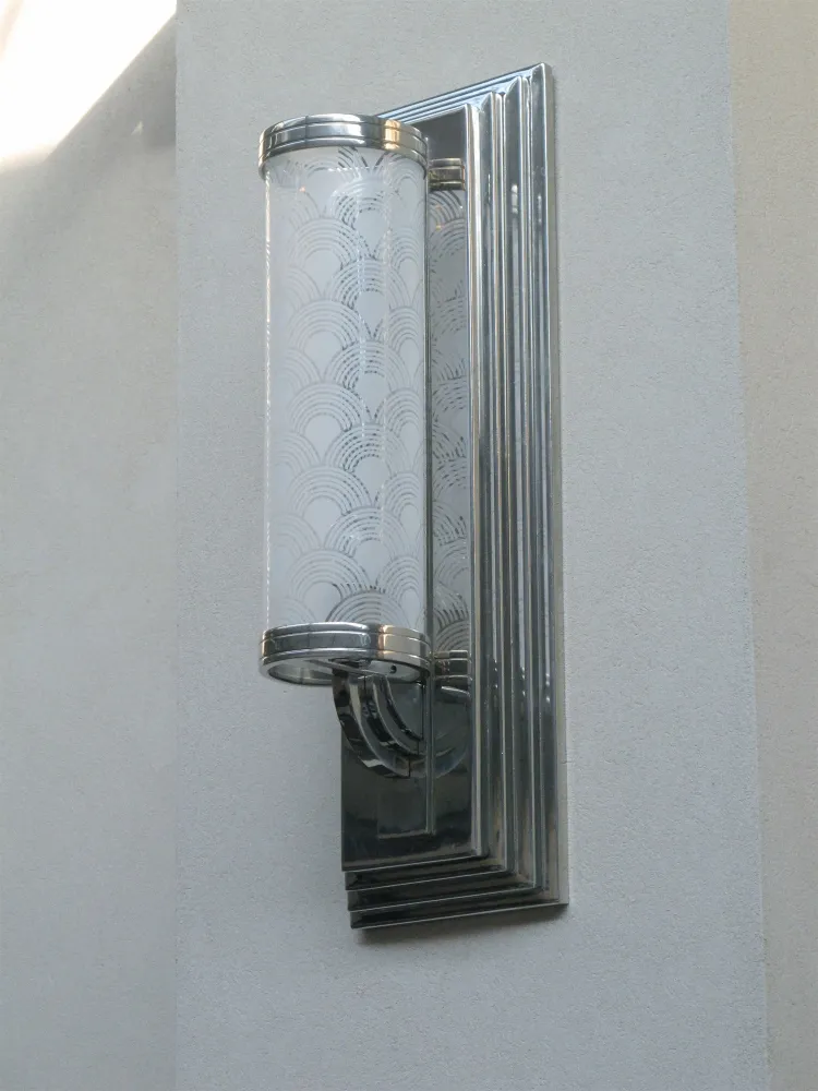 Antique wall sconce with elegant design and etched glass