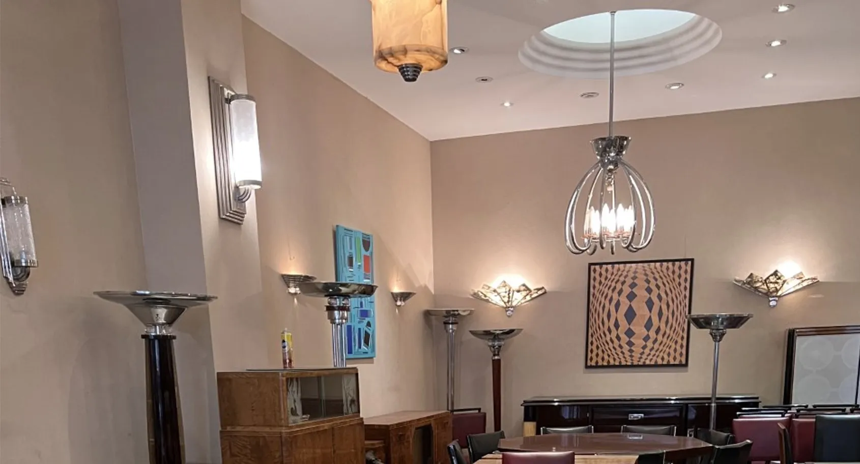 Antique pair of sconces placed near modern wall decor