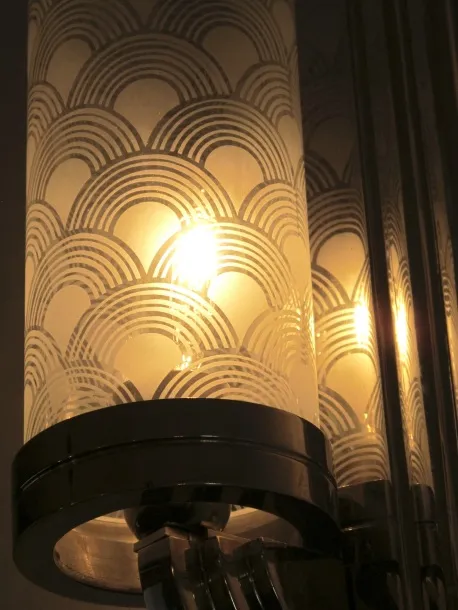 antique sconces with wavy design and warm light