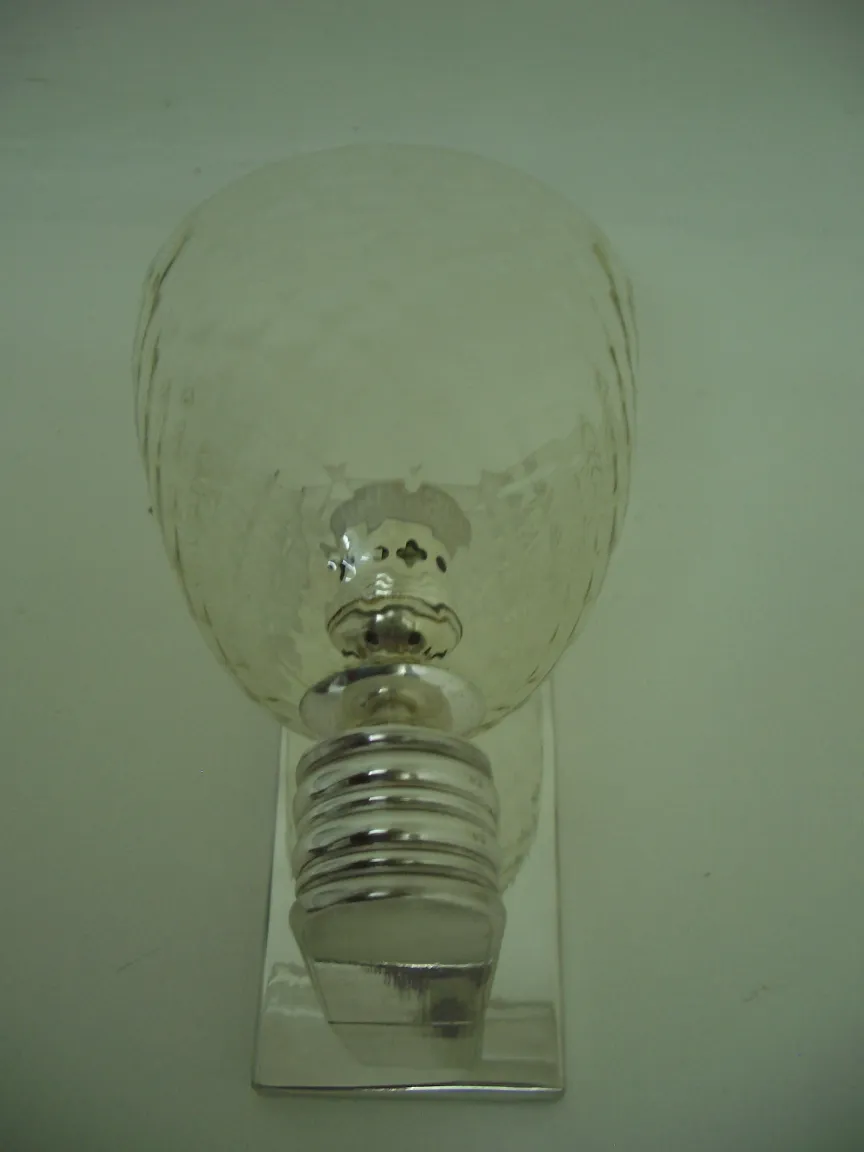 Pair of antique sconces with elegant design and clear glass.