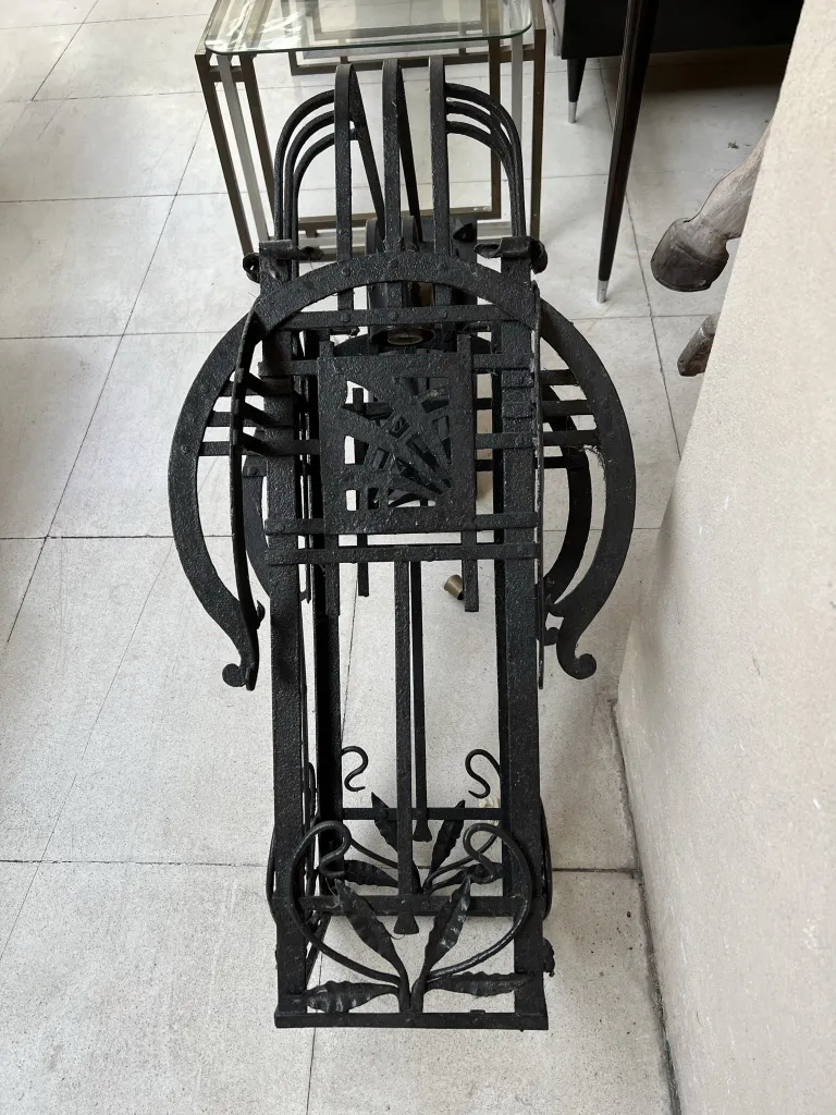 Antique pair of sconces with elegant black metal design, modern setting.