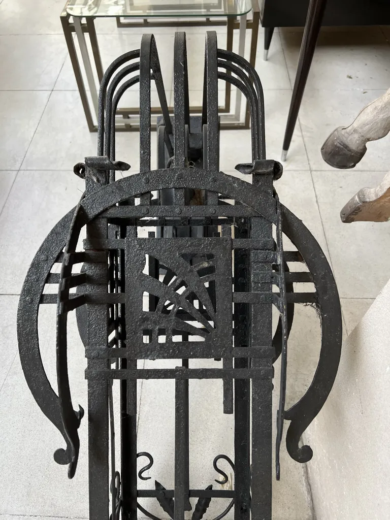 Pair of antique sconces with ornamental design in a modern setting.