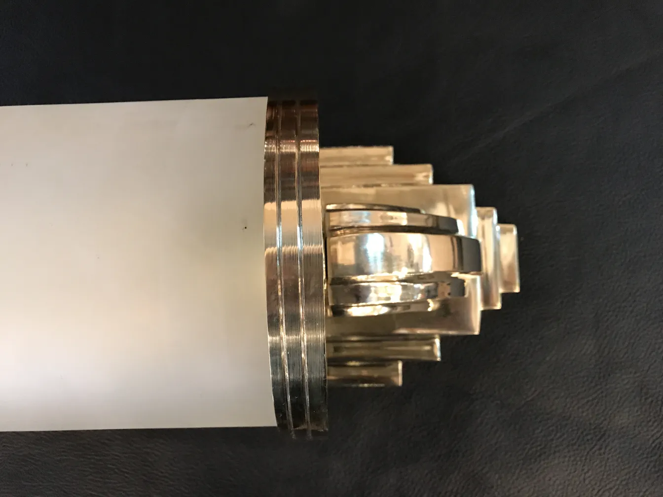 Pair of antique sconces featuring decorative details and an elegant finish.