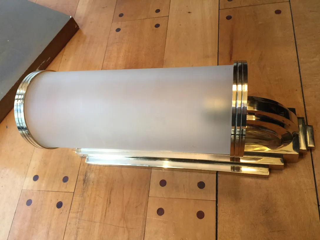 Elegant pair of antique sconces with a gold finish and frosted glass, perfect for decoration.