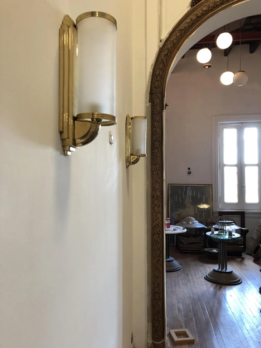 pair of antique sconces with soft light, enhancing a hallway