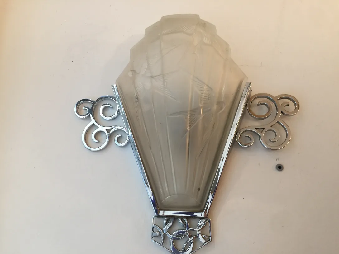 Pair of antique sconces with elegant base and decorative diffuser.