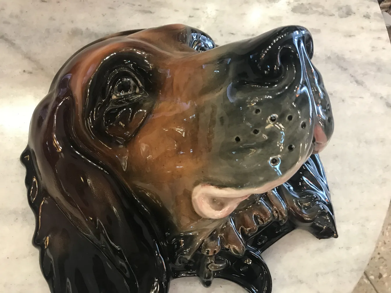 Antique ceramic dog with glossy glaze details.