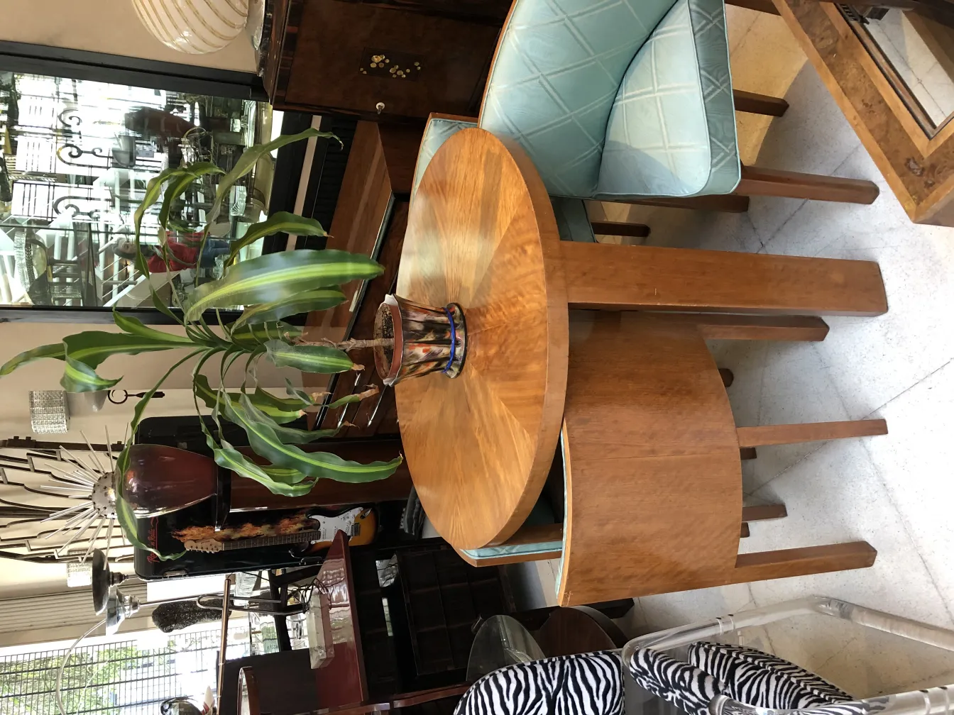 Antique decorative ceramic on wooden table with plants.
