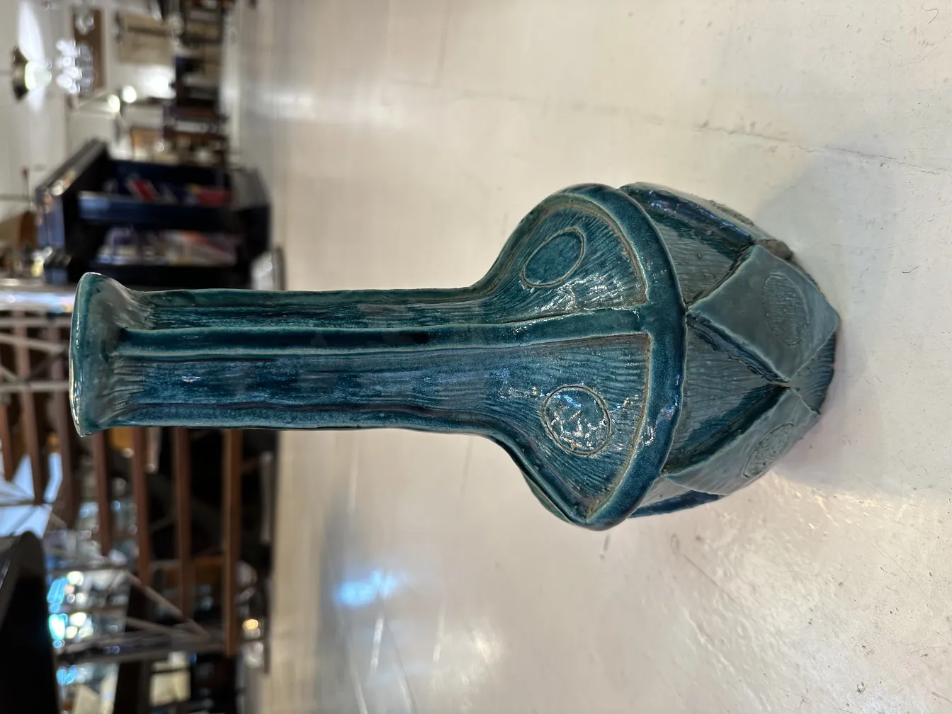 Antique decorative blue ceramic base, featuring intricate details on the surface.