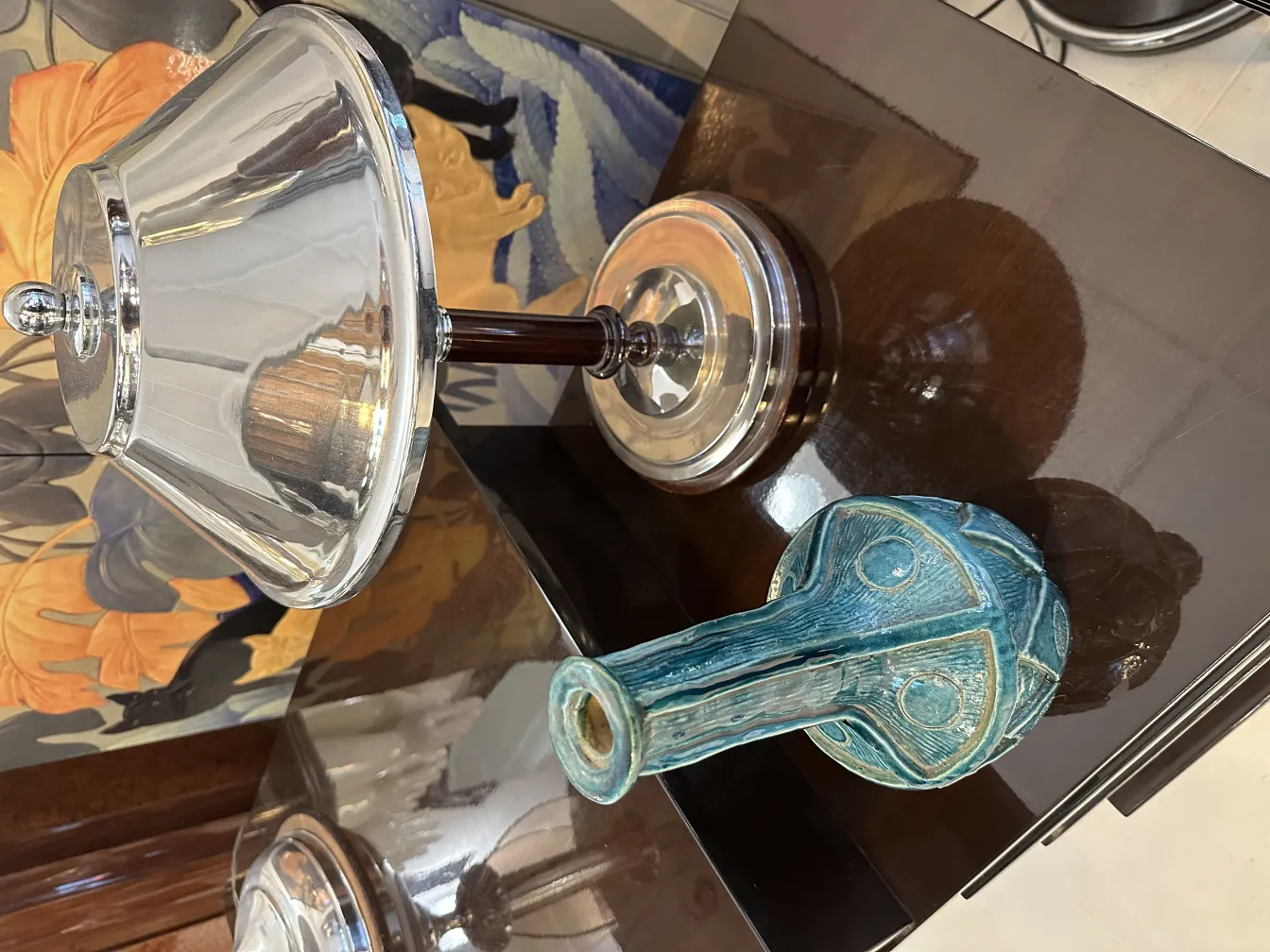 Vaso in ceramica antica con dettagli blu, sfondo in legno.