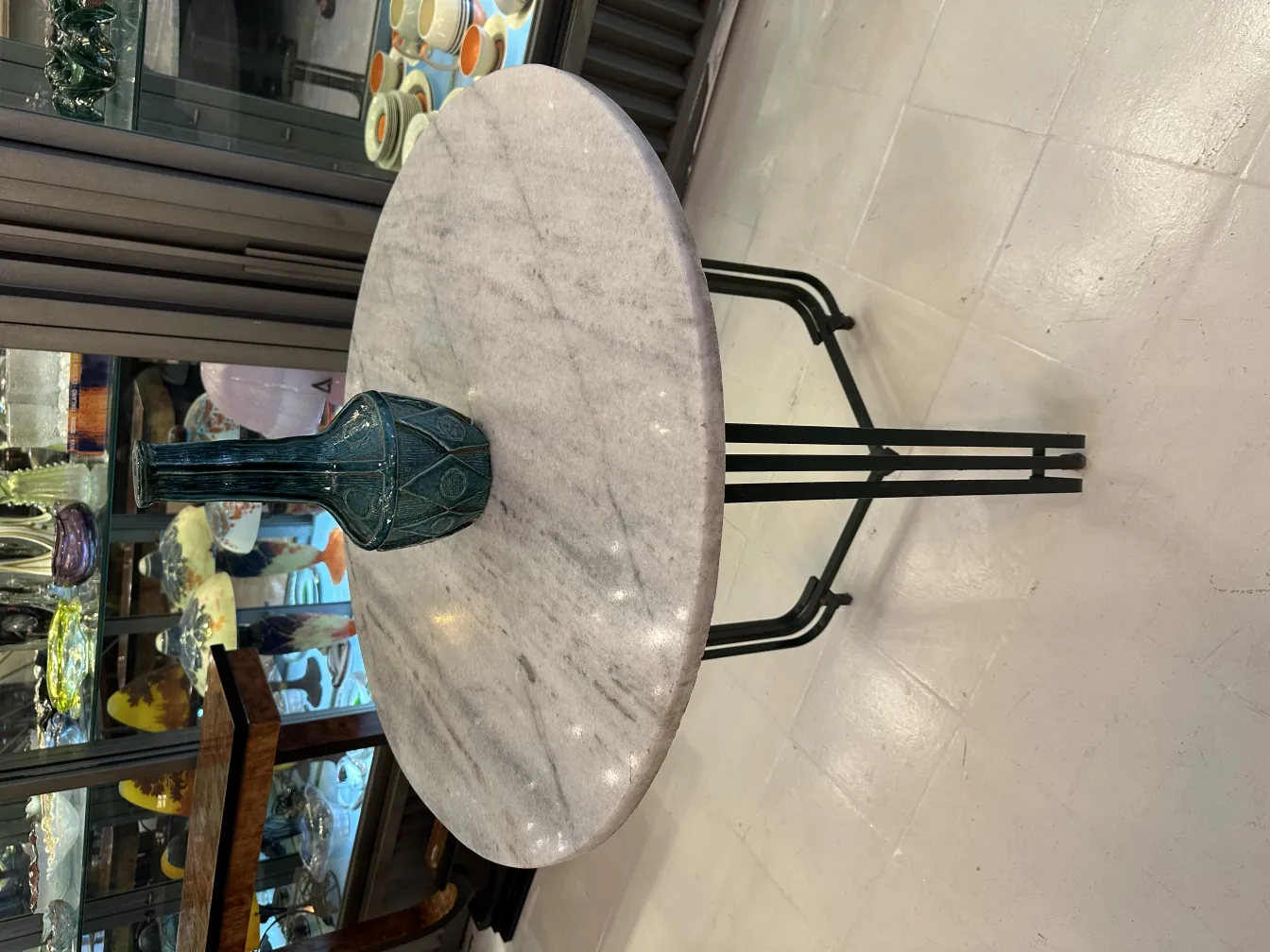 Antique decorative ceramic vase on marble table.