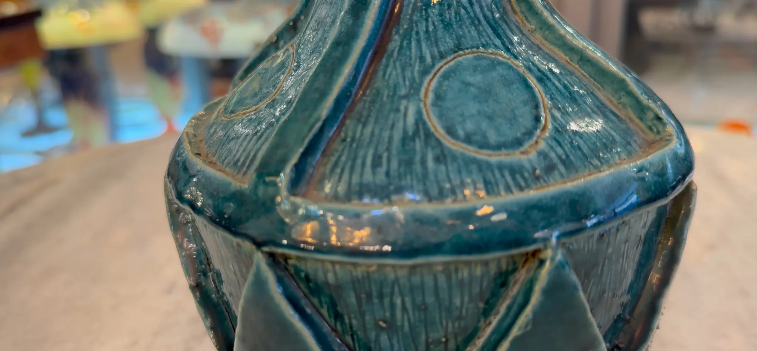 Antique ceramic vase featuring blue design and relief