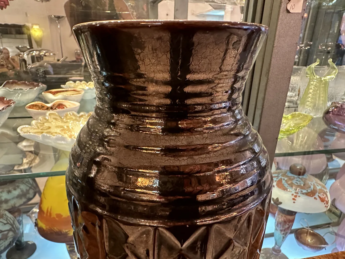 Antique ceramic vase with glossy finish and artistic details.