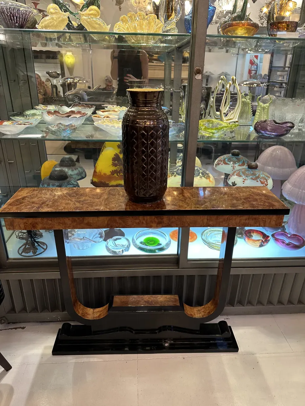 antique vase on decorative table with ceramics in the background