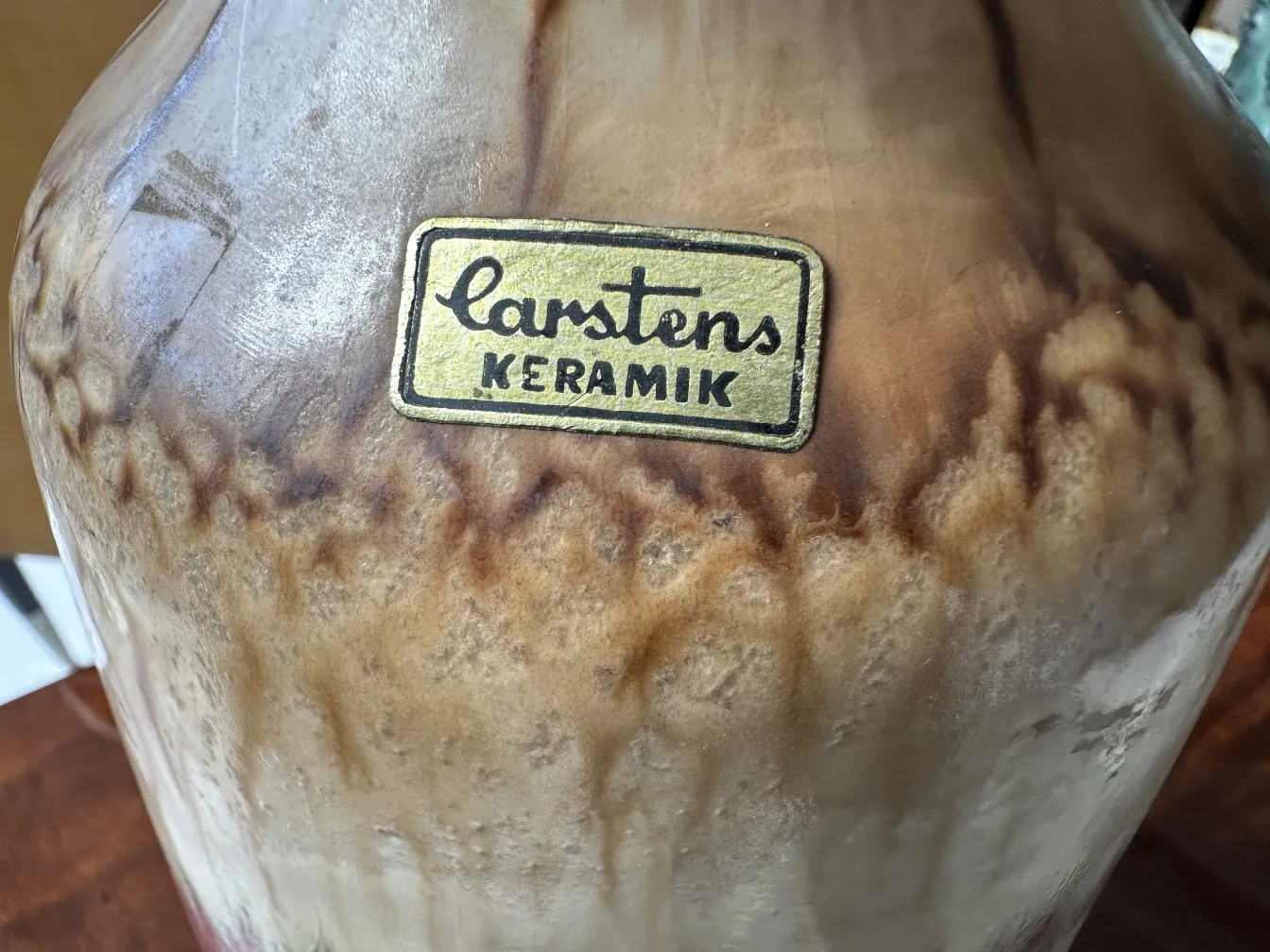 Antique ceramic vase with gold accents and unique textures.