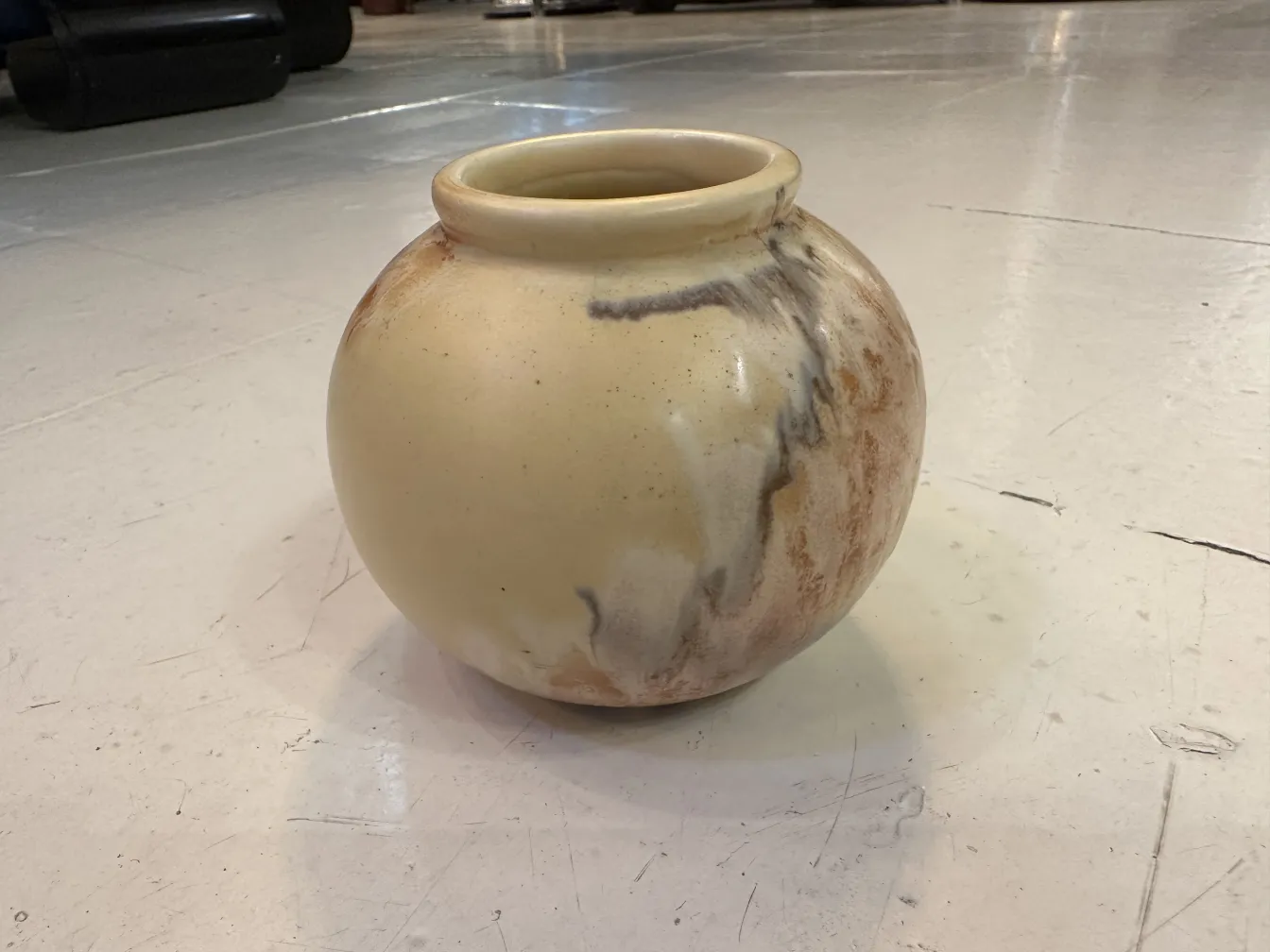 Ancient ceramic vase with artisanal design, soft tones.