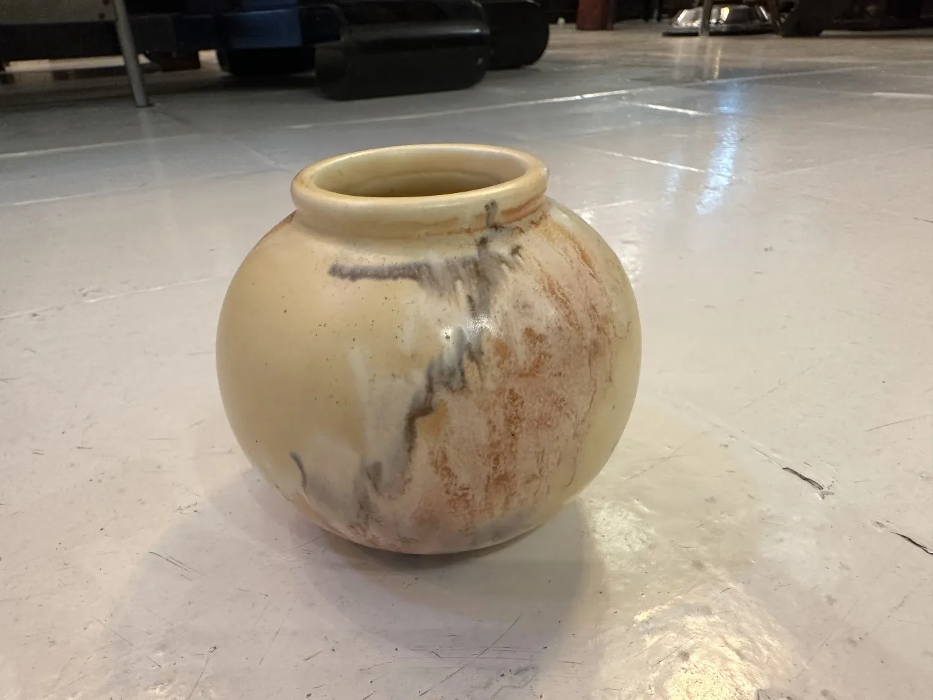 Runder Keramikvase mit einzigartigen Designs in Creme- und Brauntönen, vor einem weißen Hintergrund. Perfekt zur Dekoration.