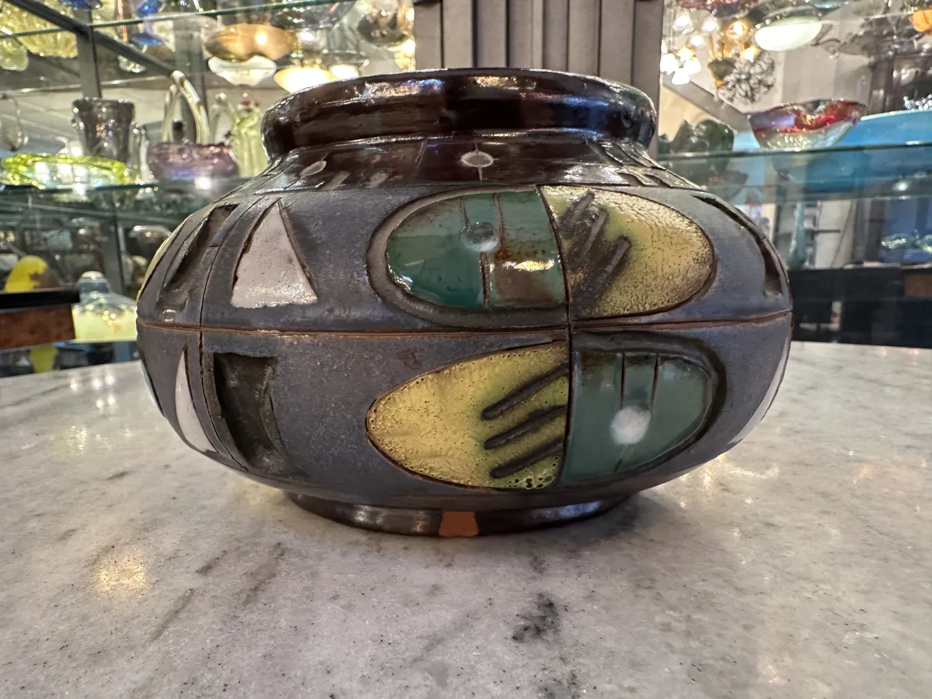 Vaso in ceramica antica con design multicolore e lucido.