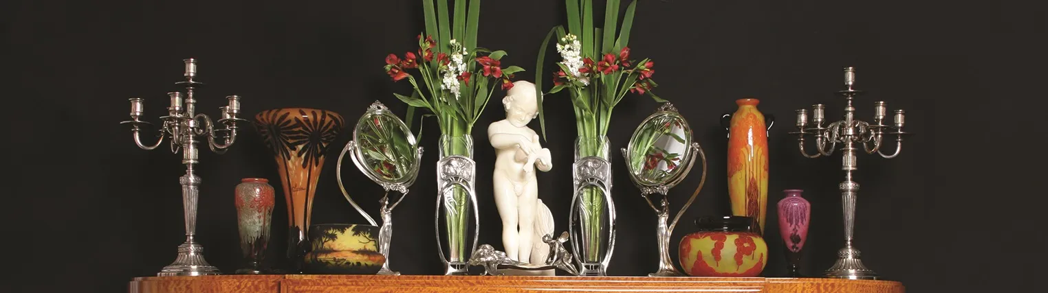 Candelabros antiguos con decoraciones florales y pequeñas estatuas