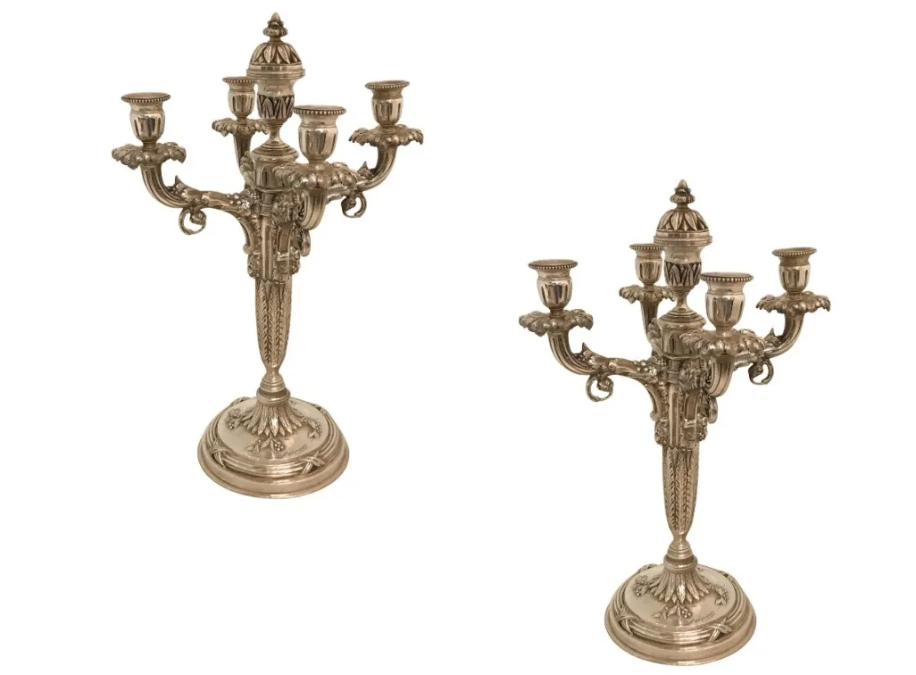 due candelabri antichi decorativi con più braccia e basi eleganti
